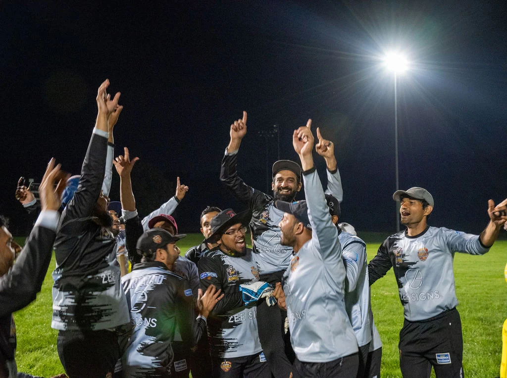 Bay Area Kings players celebrating at a night cricket event